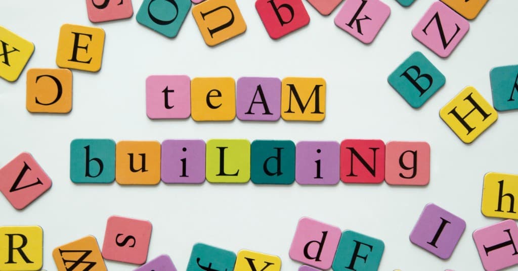 Színes betűkockákból kirakott team building felirat